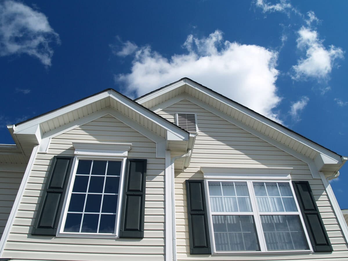 Closeup of Suburban Home with bright blue sky and white clouds