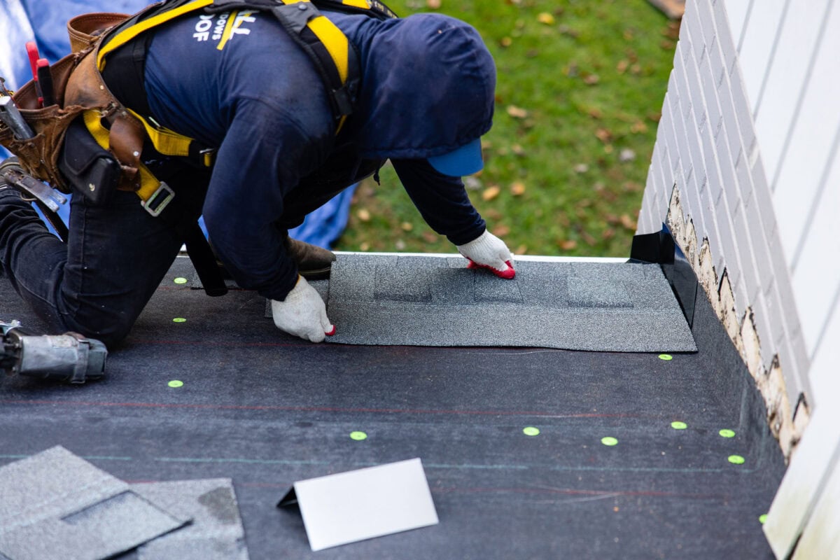 Marshall Roofing crew repairing asphalt shingles for a roofing company Manassas homeowners can trust