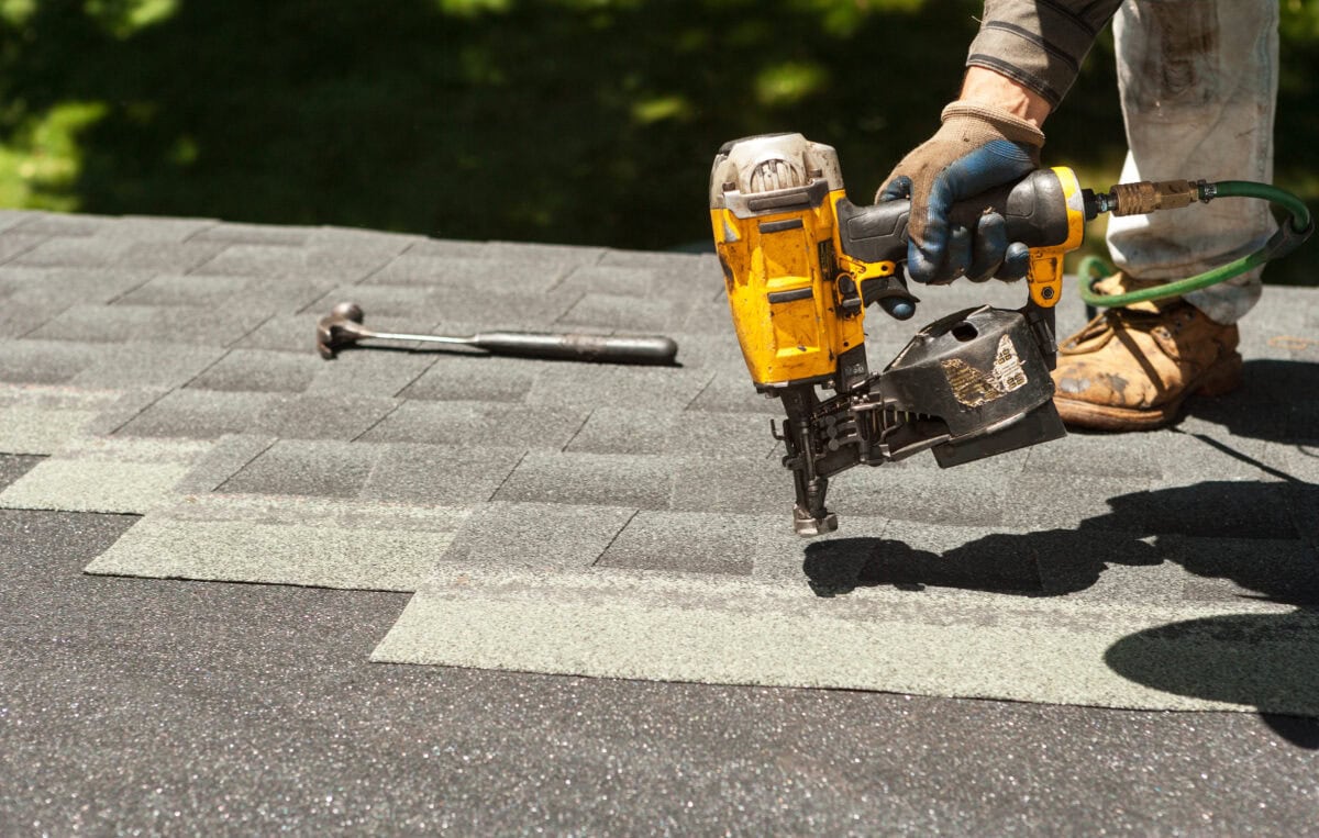 Roofing contractor installing asphalt shingles in Fairfax VA