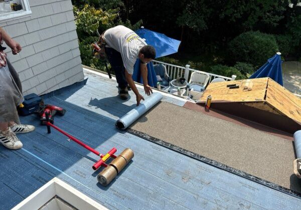 Roofing crew installing asphalt shingles on a Fairfax Virginia home
