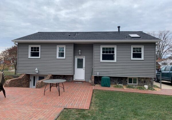 Gray home exterior with new siding installed by professional siding replacement services.